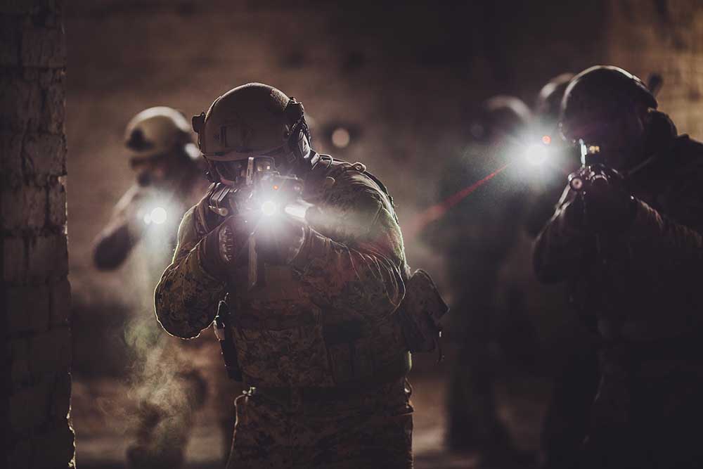rangers during the military operation with laser sights and lanterns. Military and police concept.